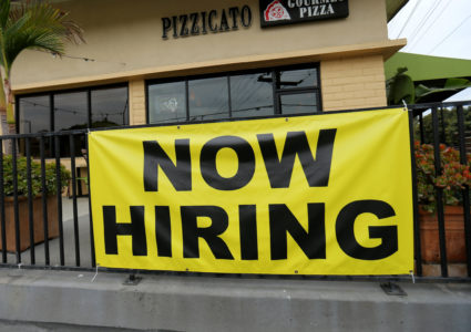 A local pizza restaurant advertises for workers in Encinitas, California