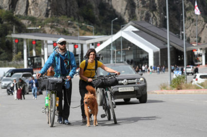 People cross border at Zemo Larsi checkpoint while leaving Russia