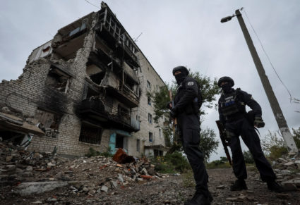 Ukrainian police patrol an area, as Russia's attack on Ukraine continues, in the town of Izium