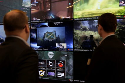 FILE PHOTO: Men look at a wall of real-time video game play in the lobby of Twitch Interactive Inc, a social video platfor...