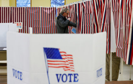Voter enters voting booth to mark his ballot in New Hampshire's first in the nation U.S. presidential primary election in ...