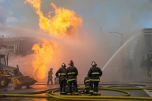 Firefighters battle a fire following an explosion at Geary boulevard and Parker Avenue in San Francisco