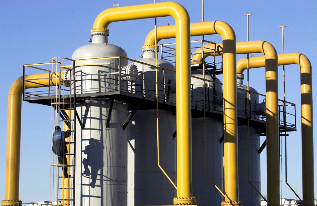 FILE PHOTO: Worker climbs cylinder at gas compressor station at Yamal-Europe pipeline near Nesvizh