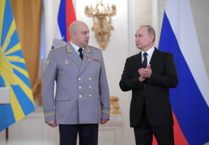 Russian President Vladimir Putin and Colonel General Sergei Surovikin, commander of Russian forces in Syria, attend a stat...
