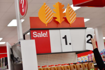 An employee alters the sale price of merchandise on a numerical sign at a Target store in King of Prussia