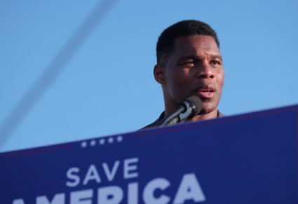 Former college football star and current senatorial candidate Herschel Walker speaks at a rally in Perry