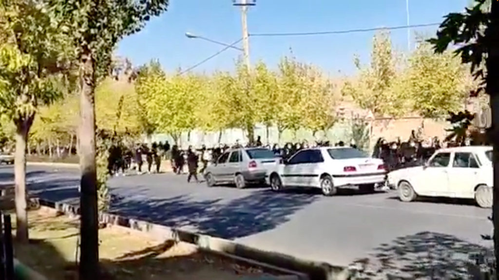 Protesters donning black march down the street following the death of Mahsa Amini in Saqez in Kurdistan Province