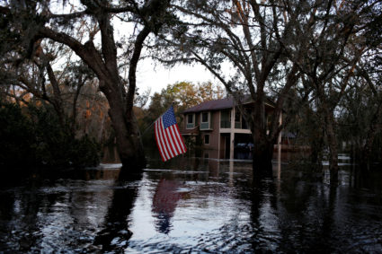 A U.S. flag is seen in a flooded rural area after Hurricane Ian caused widespread destruction in Arcadia, Florida, U.S., October 4, 2022. Photo by Marco Bello/REUTERS