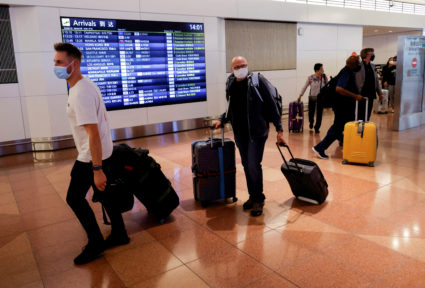 Foreign travelers walk upon their arrival at the Haneda International Airport, on the first day after Japan opened its doors to tourists after closing them for two-and-a-half years due to travel restrictions sparked by the outbreak of the coronavirus disease (COVID-19) pandemic, in Tokyo, Japan October 11, 2022. Photo by Issei Kato/REUTERS