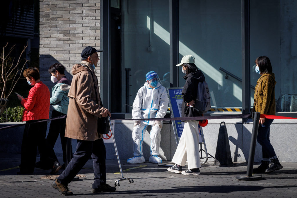A health worker wears a protective suit near a testing booth as outbreaks of coronavirus disease (COVID-19) continue in Be...