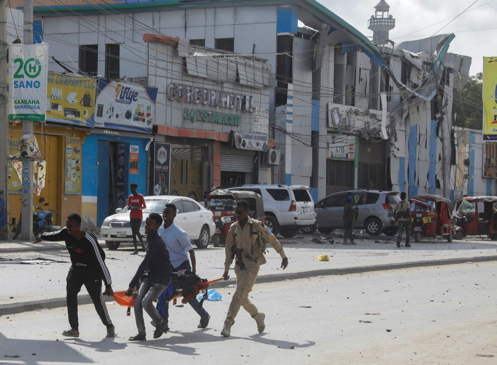 An injured civilian is evacuated from the scene of an explosion near the education ministry building along K5 street in Mo...