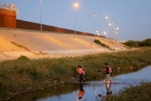 Asylum-seeking migrants from Venezuela cross the Rio Bravo river in Ciudad Juarez