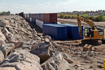 Shipping containers block a void in the wall as that prevent migrants attempting to cross in to the U.S. from Mexico at the border August 19, 2022 in San Luis, Arizona. Photo by Nick Ut/Getty Images