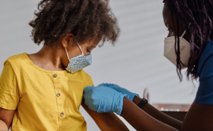 Little girl taking a vaccine from her doctor, pediatrist