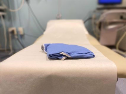 generic medical examination table &amp; patient gown
