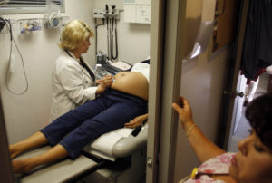 Guadalupe Hernandez receives an ultrasound by nurse practitioner Gail Brown during a prenatal exam at the Maternity Outrea...