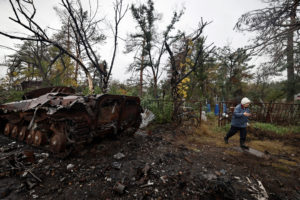 Raiisa, 71, who said she was preparing the grave to bury her husband who died of illness during the Russian occupation of ...