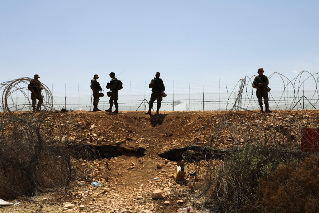 Israeli soldiers guard along a fence leading to the Israeli-occupied West Bank, as part of search efforts to capture six P...