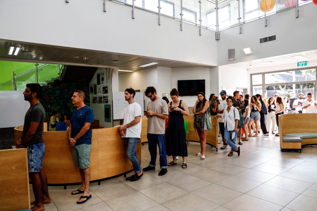 People cast their vote in Israel's general election in a polling station in Tel Aviv