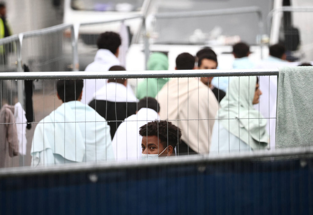 People inside a containment area inside a migrant processing centre in Manston