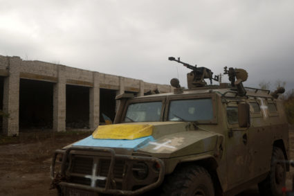 Ukrainian service members ride a previously captured Russian armoured personnel carried in the village of Blahodatne in Kh...