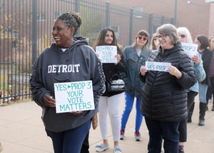 FILE PHOTO: Abortion rights activist Fabian Hill holds a sign while waiting in line to see former U.S. President Barack Ob...