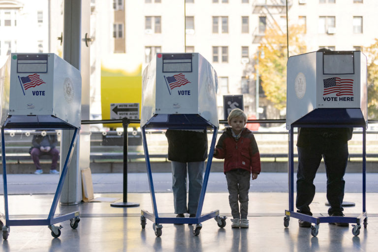 FILE PHOTO: Voters cast their ballot at a polling station during early voting in New York City