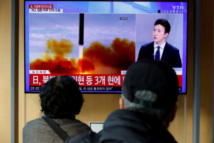 FILE PHOTO: People watch a TV broadcasting a news report on North Korea firing a ballistic missile off its east coast, in ...