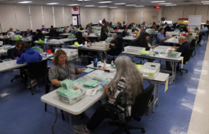 Early ballots are opened and processed before being counted in Phoenix