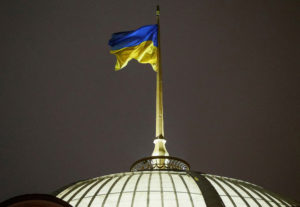 FILE PHOTO: A Ukrainian national flag flies over the parliament building in Kyiv