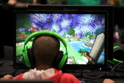 Child plays video game Minecraft at the Minecon convention in London