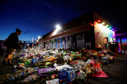 Cheerish Martin looks at the notes and mementos left at a memorial in front of Club Q after a mass shooting at the LGBTQ nightclub, in Colorado Springs, Colorado, U.S. November 26, 2022. Photo by Isaiah J. Downing/REUTERS