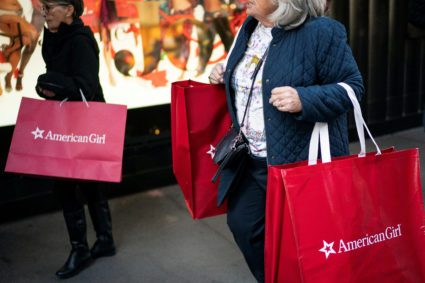 People carry shopping bags along 5th Avenue during the holiday season in New York