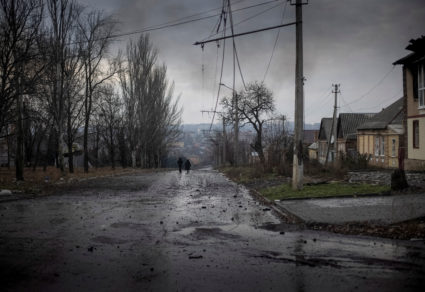 Local residents walk down a street in Bakhmut