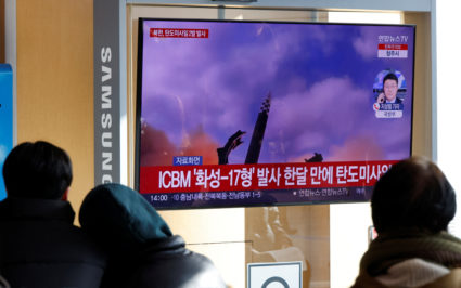 People watch a TV broadcasting a news report on North Korea firing a ballistic missile off its east coast, in Seoul