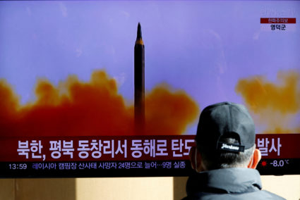 FILE PHOTO: A man watches a TV broadcasting a news report on North Korea firing a ballistic missile off its east coast, in Seoul