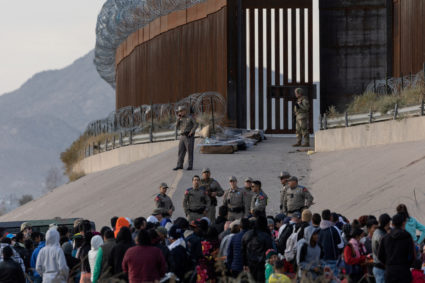 Asylum-seeking migrants wait at the border between Mexico and the U.S., in Ciudad Juarez