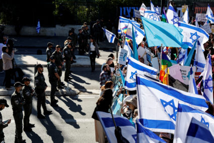 Israelis protest outside Israel's parliament, on the day that a new right-wing government is sworn in, with Benjamin Netan...
