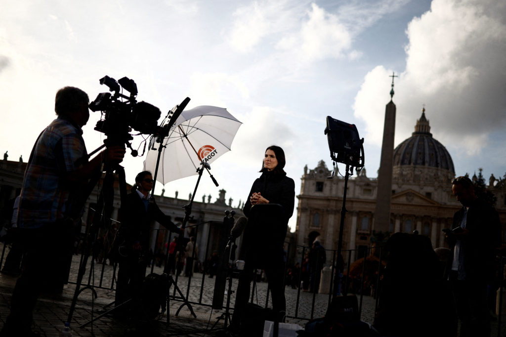 People gather following the announcement of the worsening of former Pope Benedict's health, at the Vatican