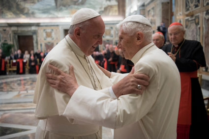 FILE PHOTO: Former pope Benedict is greeted by Pope Francis during a ceremony to mark his 65th anniversary of ordination t...