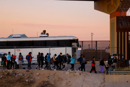 Asylum-seeking migrants cross the Rio Bravo river in Ciudad Juarez