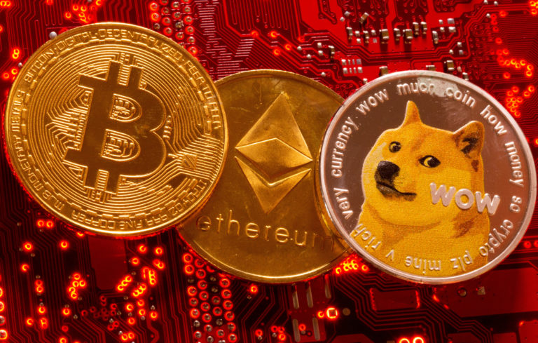 FILE PHOTO: Representations of cryptocurrencies Bitcoin, Ethereum and DogeCoin are placed on PC motherboard in this illust...