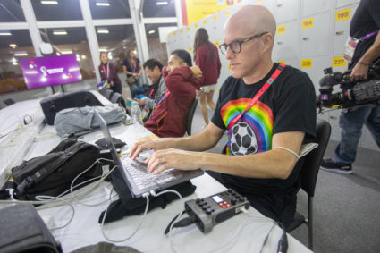 Journalist Grant Wahl (right) works in the FIFA Media Center before a World Cup match between Wales and the U.S. at Ahmad Bin Ali Stadium on Nov. 21, 2022 in Al Rayyan, Qatar. Photo by Doug Zimmerman/ISI Photos/Getty Images