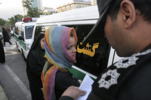 Morality police take down the name of a detained woman during a crackdown on "social corruption" in north Tehran