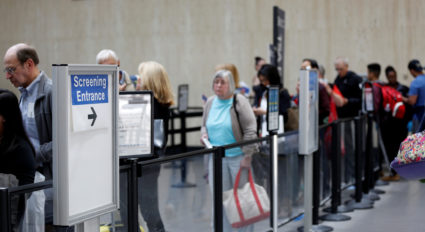 Travelers stand in line to go through Transportation Security Administration (TSA) check-points at Los Angeles Internation...