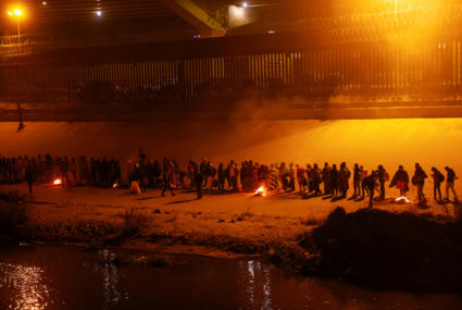 Migrants stand near the border wall after crossing the Rio Bravo river to turn themselves in to U.S. Border Patrol agents to request asylum in El Paso, Texas, U.S., after the U.S. Supreme Court said Title 42 should stand as is for now, as seen from Ciudad Juarez, Mexico December 19, 2022. Photo by Jose Luis Gonzalez/REUTERS