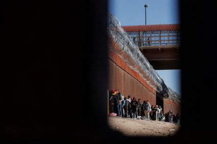 Asylum-seeking migrants wait at the border between Mexico and the U.S.,