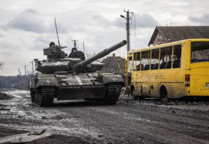 Ukrainian servicemen ride a tank in the village of Torske