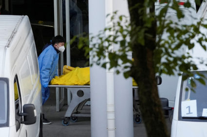 Staff member pushes a cart carrying a body in a bag at a funeral home, as COVID-19 outbreaks continue in Shanghai