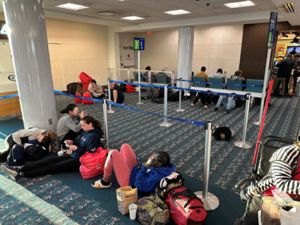 Stranded passengers wait at Orlando International Airport, as flights were grounded after FAA system outage, in Orlando